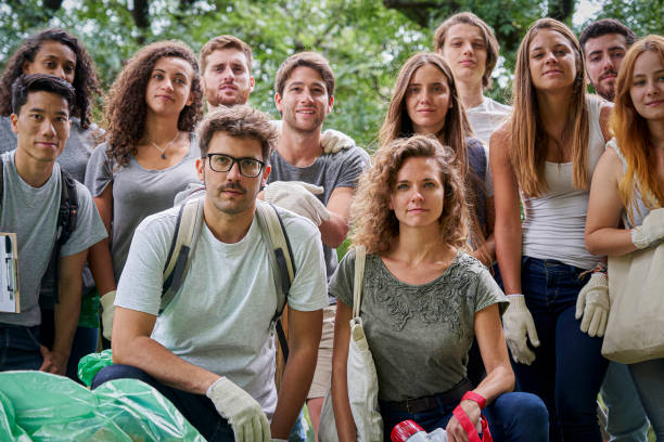 istock Group of multiethnic environmental activists posing for the camera in a park 1306495350
