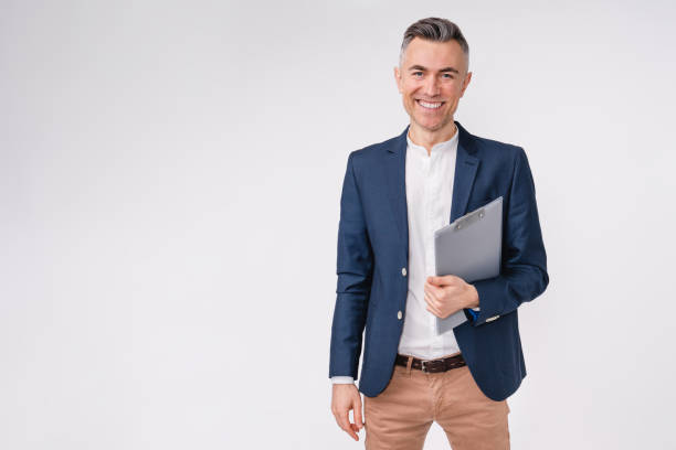 confident mature caucasian businessman holding clipboard isolated over white background - business man imagens e fotografias de stock