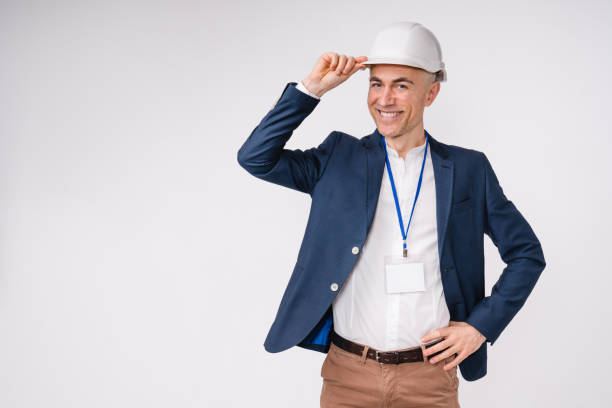 istock Confident handsome middle-aged engineer in hardhat isolated over white background 1306498095