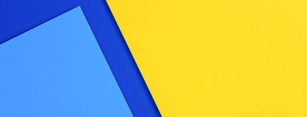 istock Creative abstract blue and yellow color geometric paper composition background, top view 1306498394