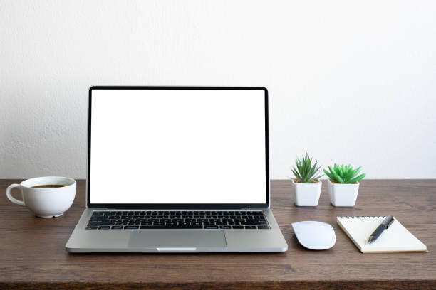 istock Laptop computer blank screen on wood office desk table with coffee cup and notebook, mouse computer with equipment office supplies. Business and finance concept. Workplace, Flat lay with copy space. 1306499238