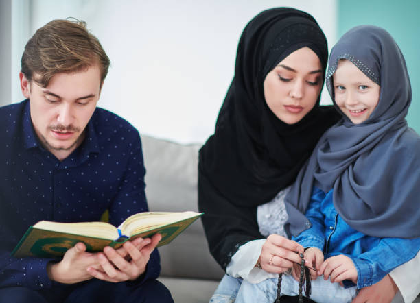 istock Young muslim family reading Quran during Ramadan 1306500185