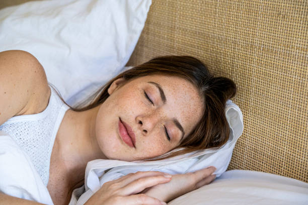 istock Close up of young woman sleeping on bed 1306500748