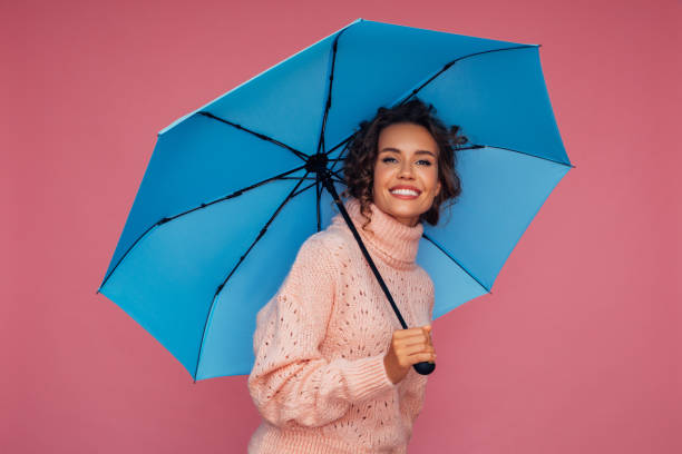 istock Girl with blue umbrella 1306501811