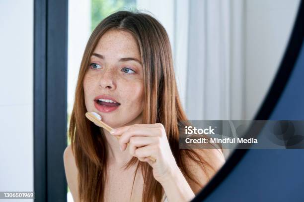Close Up Of Young Woman Brushing Her Teeth At Home Stock Photo - Download Image Now - Toothbrush, Teeth, Bamboo - Material