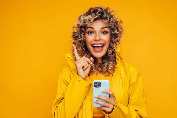 istock Beautiful smiling woman using smart phone 1306502715