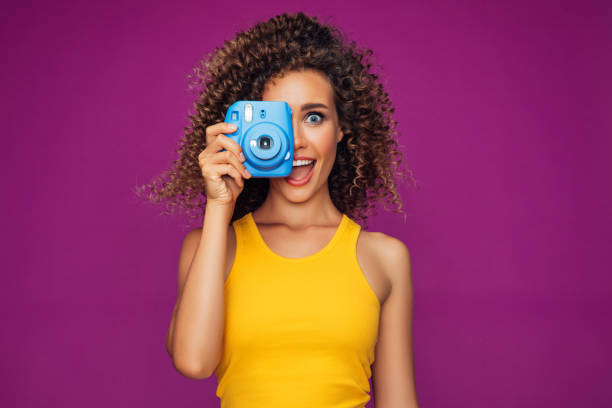 istock Happy beautiful woman with analog camera 1306503517
