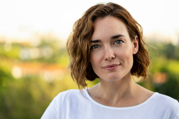Portrait of smiling woman Portrait of smiling woman standing outdoors 35 39 years stock pictures, royalty-free photos & images