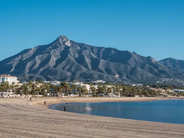 Photo of Beach of Puerto Banus with the mountains of Sierra Blanca at background, Marbella, Costa del Sol, Malaga province, Spain