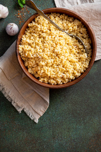 istock Cooked bulgur in a bowl on a dark background 1306505583