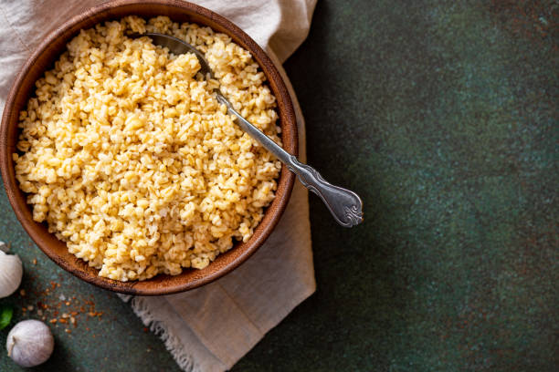 istock Cooked bulgur in a bowl on a dark background 1306505650