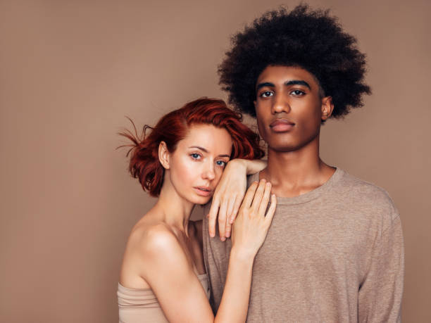 Interracial couple smiling and holding one another