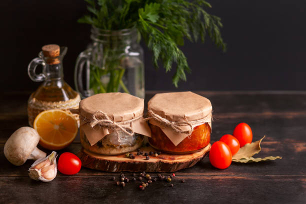 Homemade canned fish from mackerel in oil and tomato paste. Glass jars with canned fish
