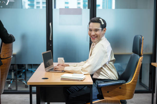 istock Young asian office worker working with laptop and document at desk in the office 1306506821
