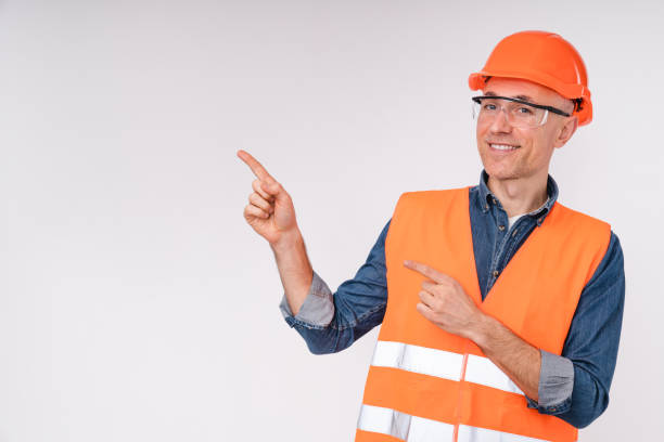 istock Cheerful caucasian construction worker pointing at copy space isolated over white background 1306506965
