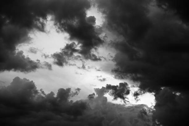 istock Black and white sky with dark storm clouds at sunset 1306507232
