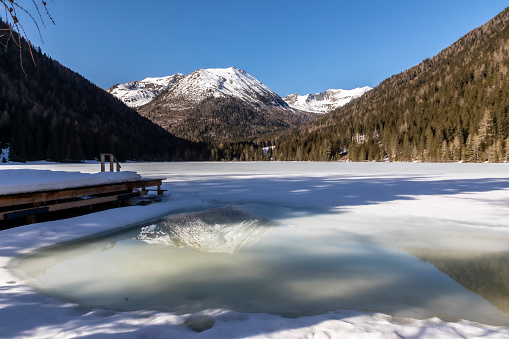 Frozen lake landscape  on Vesteralen in Northern Norway during a beautiful winter day with snow and ice.