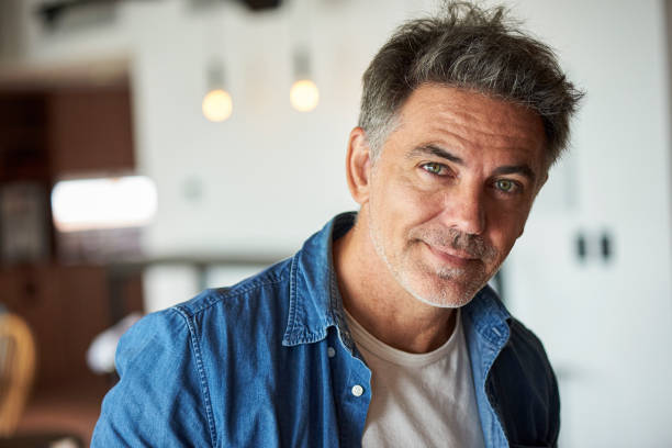 istock Portrait of smiling mature man 1306508499