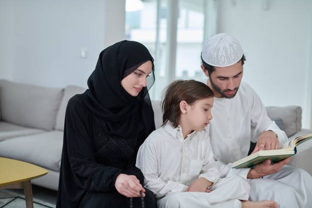 istock Young muslim family reading Quran during Ramadan 1306510005