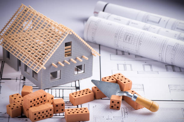 istock House in construction - project with brick and blueprint 1306510210