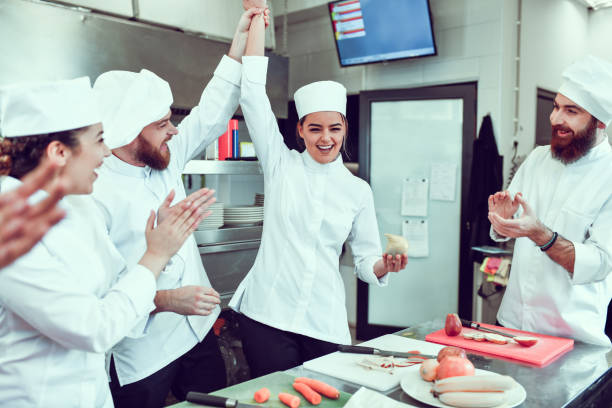 istock Female Winning Vegetable Cutting Competition In Restaurant Kitchen 1306510356