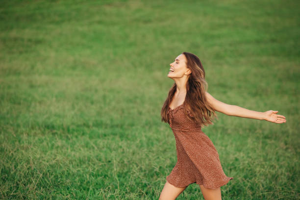 istock Beautiful woman running on the field 1306510464