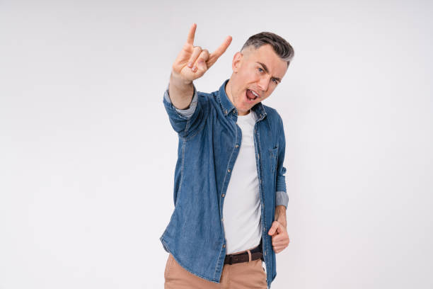 istock Excited caucasian middle-aged man showing rock-n-roll gesture isolated over white background 1306510489