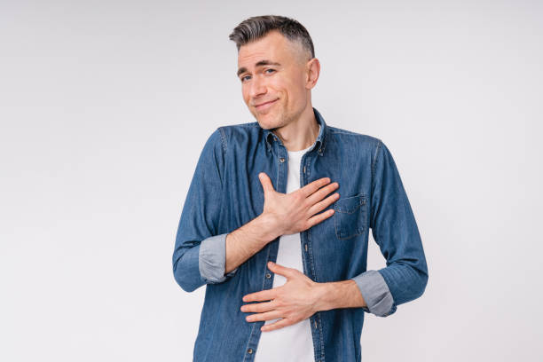 istock Touched by a compliment handsome caucasian man isolated over white background 1306510503
