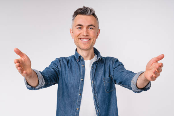Cheerful caucasian mature man wants to hug isolated over white background stock photo