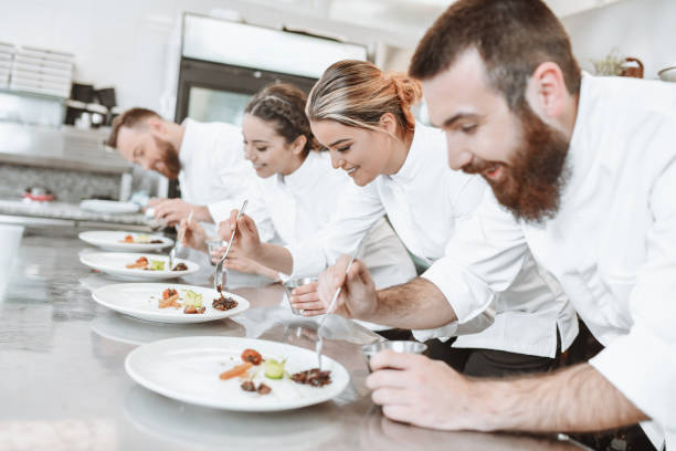 istock Cooks Trying To Win Competition By Making Best Fruit Dessert 1306512090