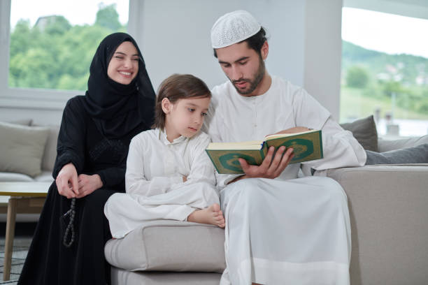 istock Young muslim family reading Quran during Ramadan 1306512176