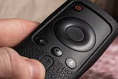 Black remote control from a set-top box in a silicone case