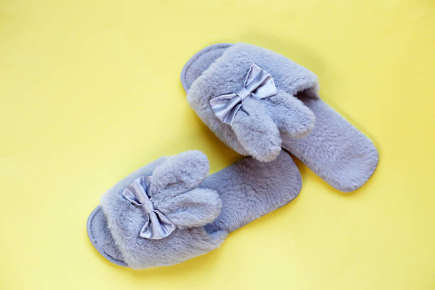 istock Pair of stylish soft slippers on yellow background, flat lay. copy space for text 1306512656