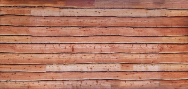 Wall of waney uneven edge wooden cladding boards Flat view of wall of rustic waney uneven edge wooden cladding boards passenger cabin photos stock pictures, royalty-free photos & images