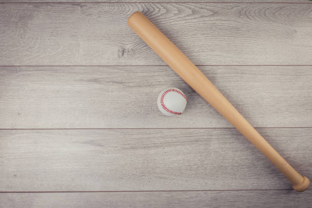 istock Baseball ball and baseball bat on wooden table 1306515294