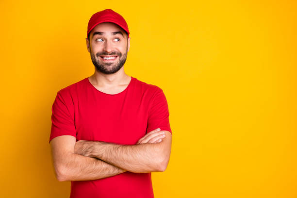 istock Portrait of nice funky content cheerful guy mailman folded arms looking aside copy space isolated over vibrant yellow color background 1306516431