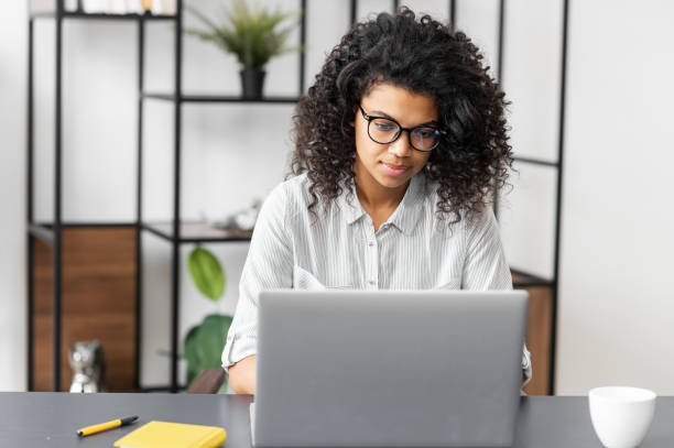 istock African American female student working on laptop 1306517128
