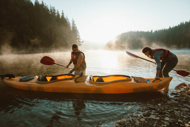 istock Young couple ready for adventures with kayak. 1306518436