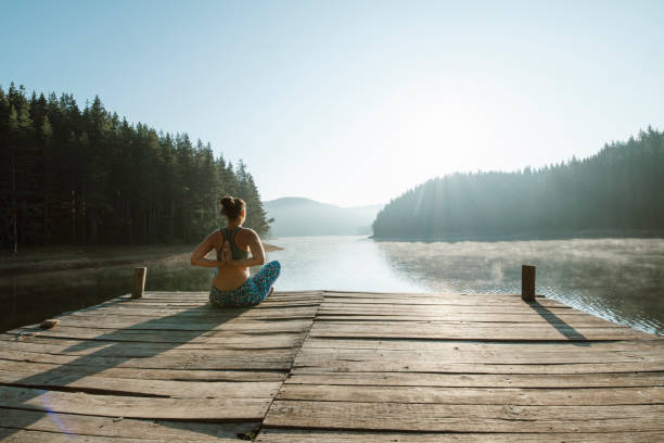 istock Young woman practicing yoga in the nature. 1306518437