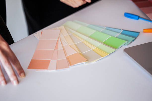 istock Close up of designers hands discussing colour samples in office 1306518702
