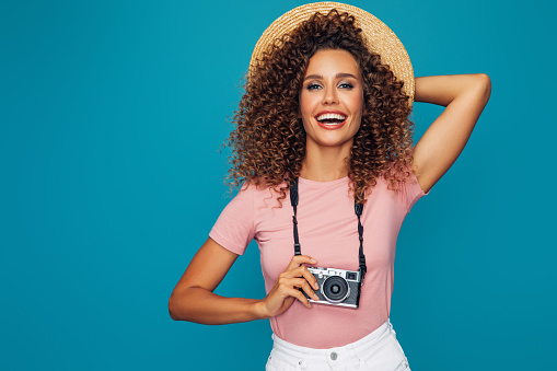 Happy beautiful woman with camera