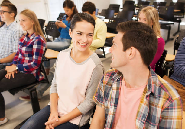istock group of smiling students in lecture hall 1306519626
