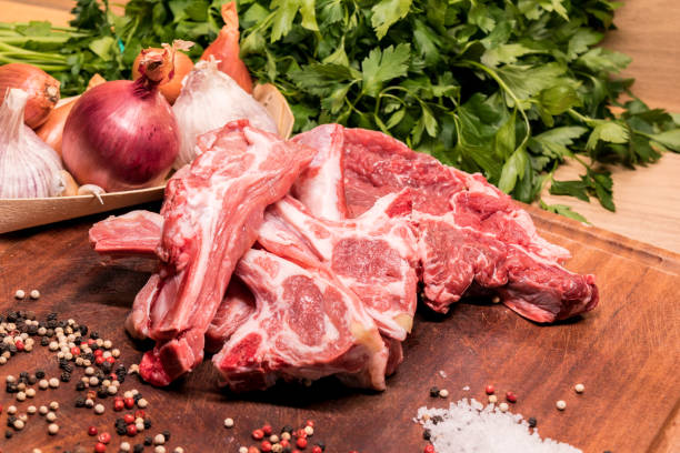 istock raw lamb chops on a wooden board for barbecue 1306521503