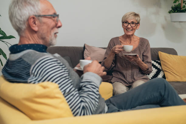 istock Senior couple drinking tea and talking together at home 1306522651
