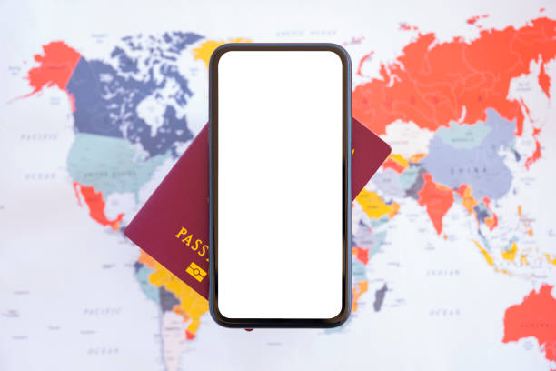 istock (Selective focus) Flat lay with copy space. A smartphone with a white screen and a passport are arranged on a blurred World Map. Concept of showing informations about the Coronavirus. 1306524180