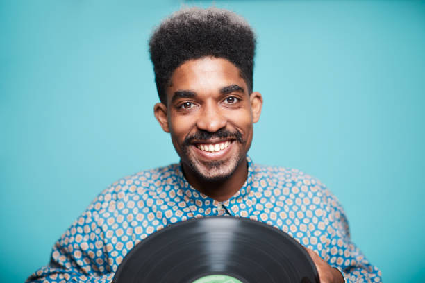 istock Jazz musician holding a long play record 1306528488