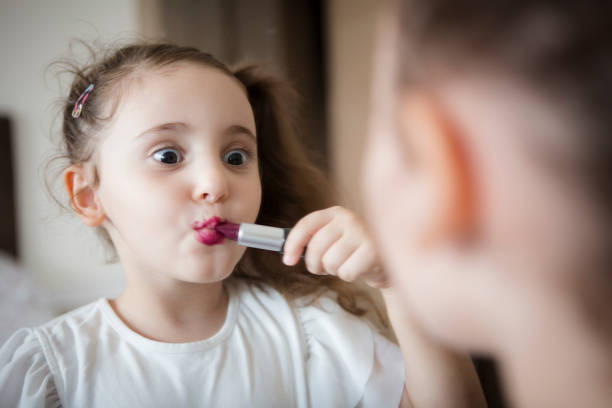 istock Little girl's first lipstick 1306529561