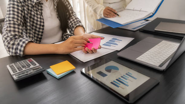 istock Business team brainstorming and discussing with financial data and report graph. Teamwork meeting working concept. 1306529780