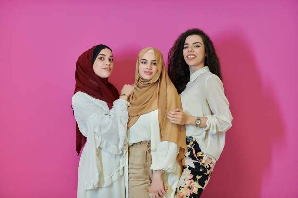 istock Young muslim women posing on pink background 1306530789