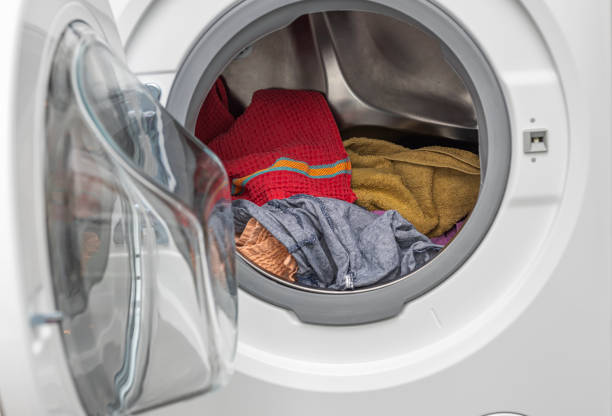 istock Close-up view of washed laundry in a laundry  machine. Home routine concept. Sweden. 1306532140